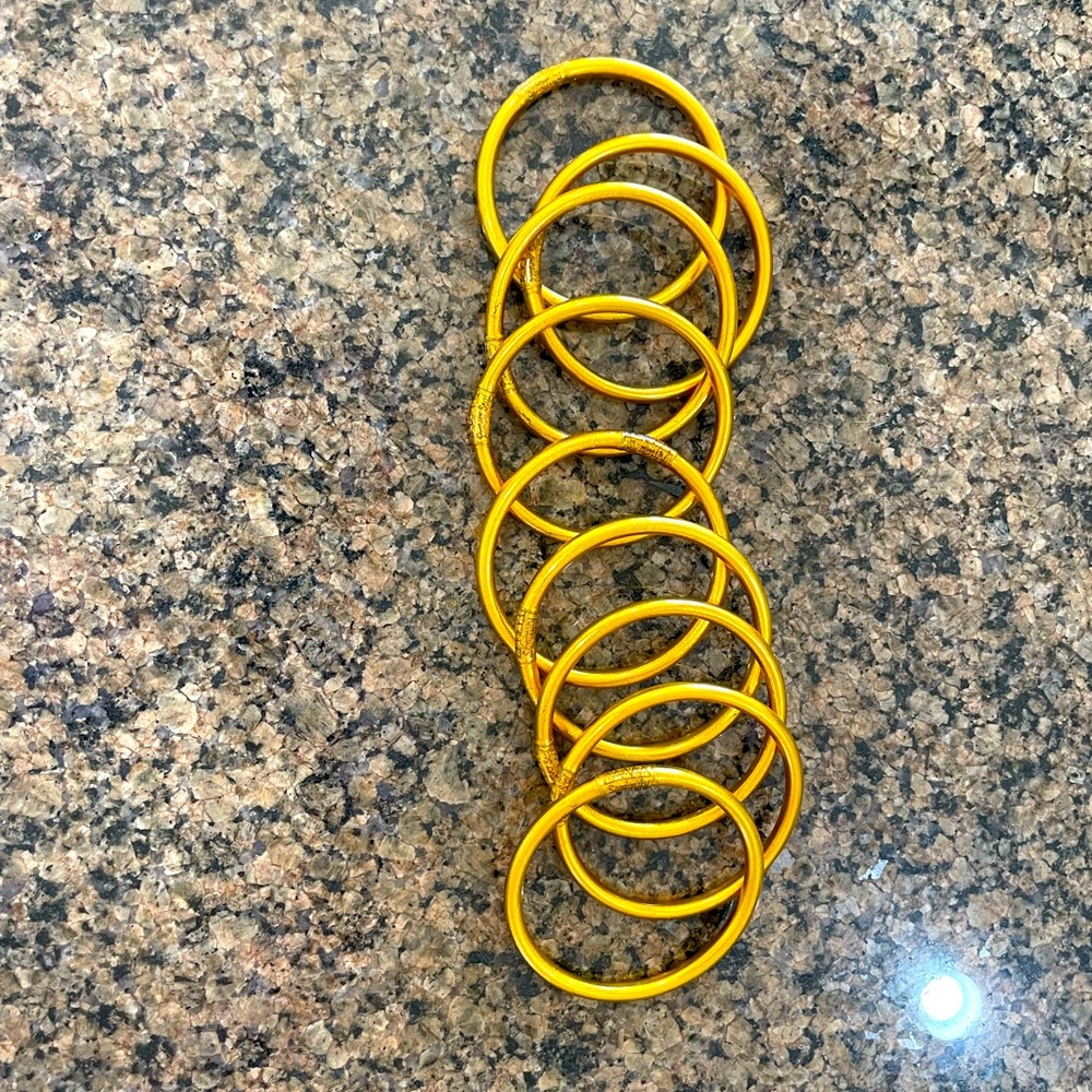 9 Gold Buddha Girl bangles, barely worn!